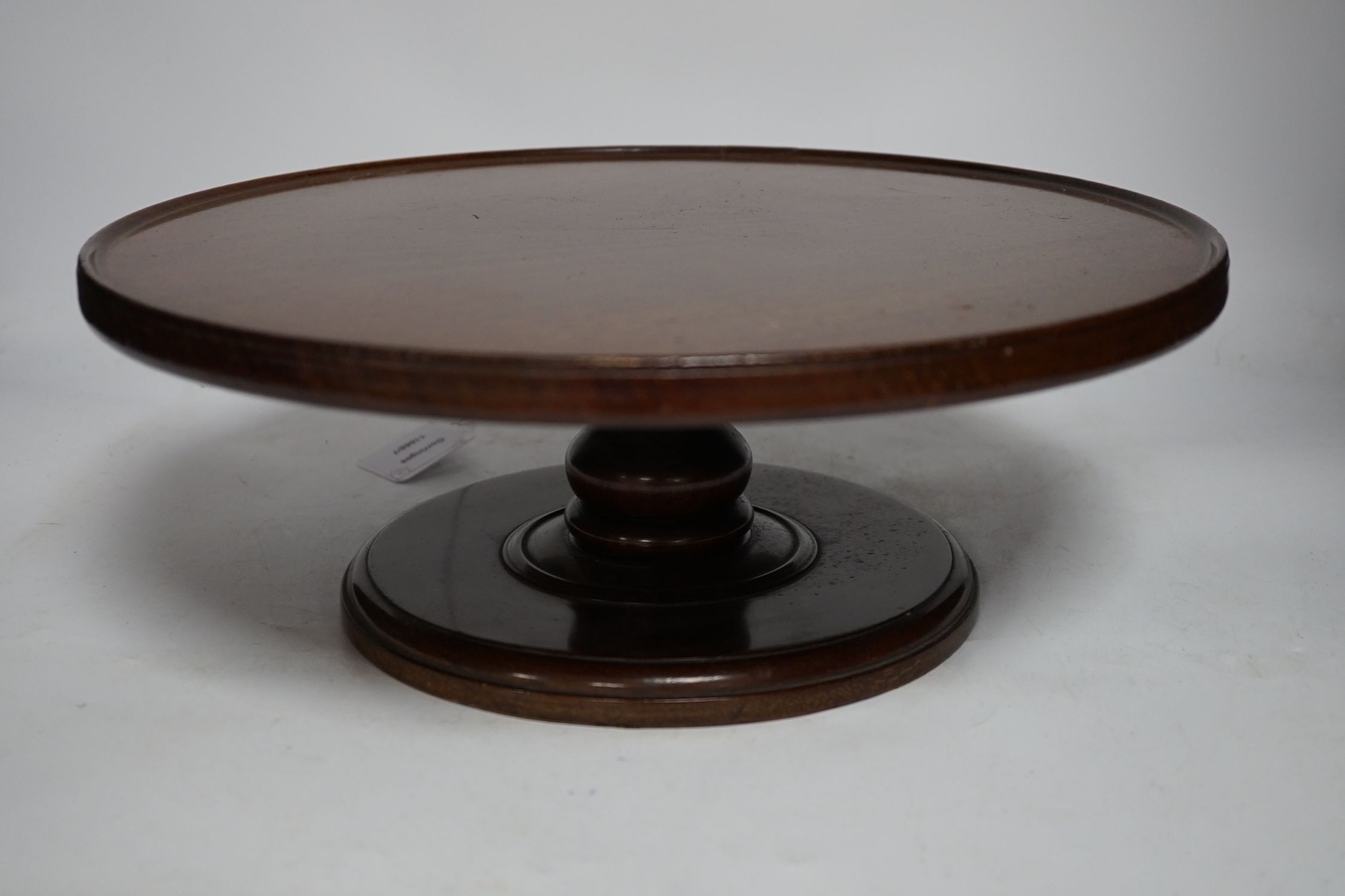 A large reproduction mahogany cheese coaster and a Lazy Susan, largest 50cm wide